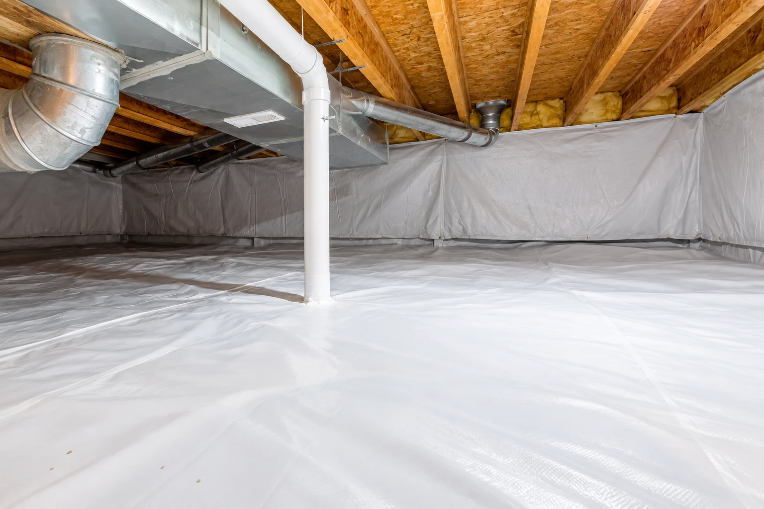 A crawl space is lined with white vapor barrier across the floor and walls, with exposed joists and ductwork above.
